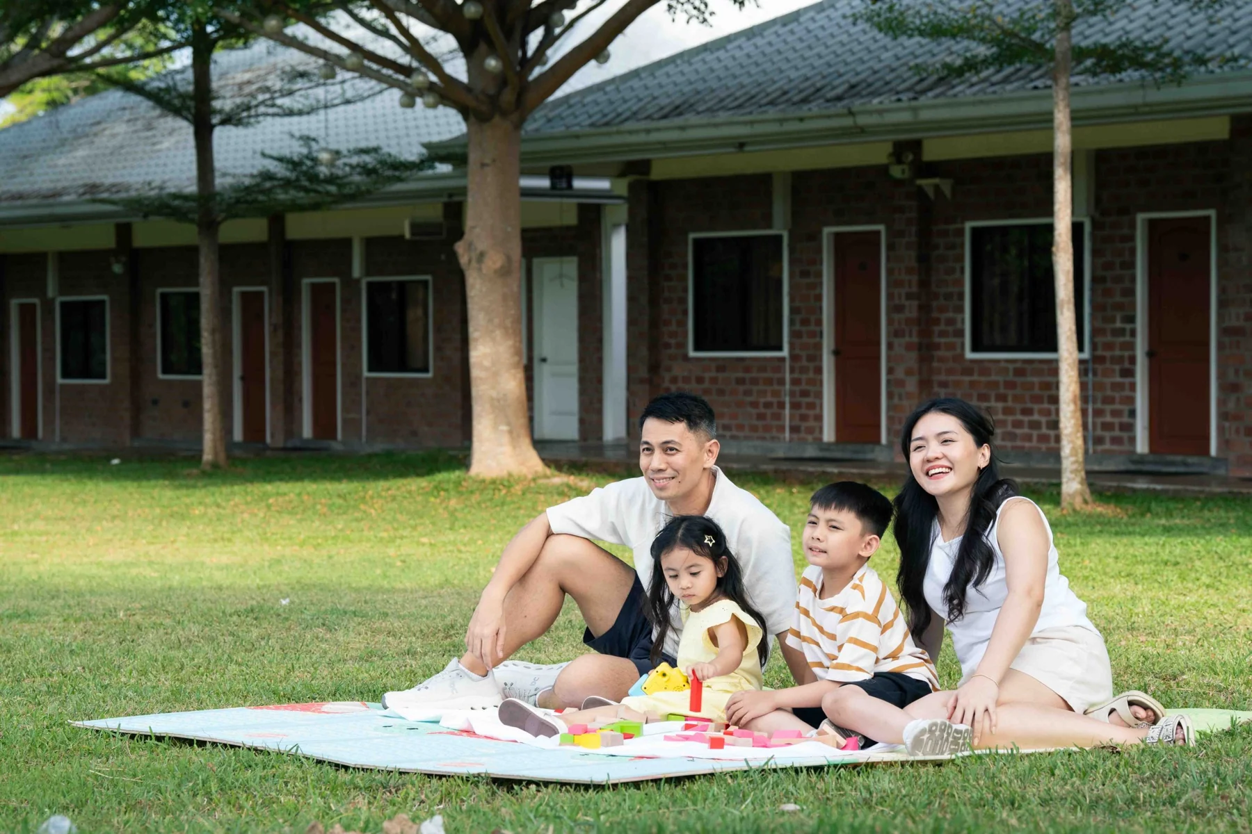 A family enjoying a picnic together on the XSCC lawn