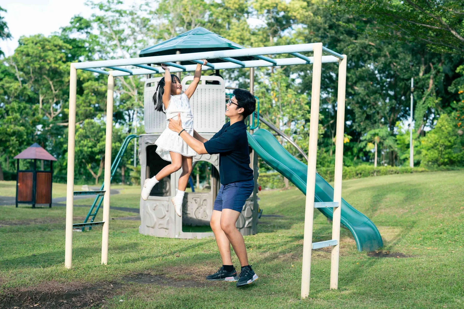 A family enjoying the gardens and swing at XSCC